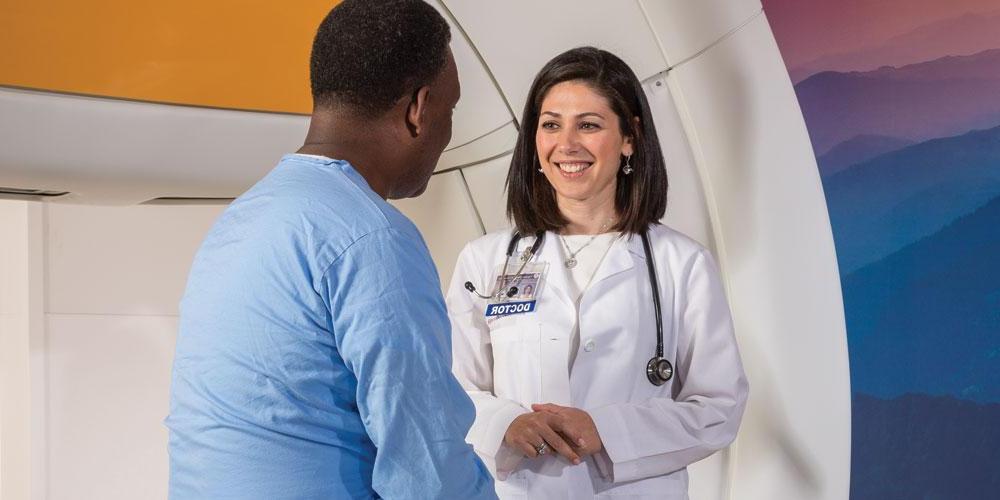 Radiation Oncologist Anna Shapiro speaks with a patient about treatment using TrueBeam, a type of stereotactic radio therapy