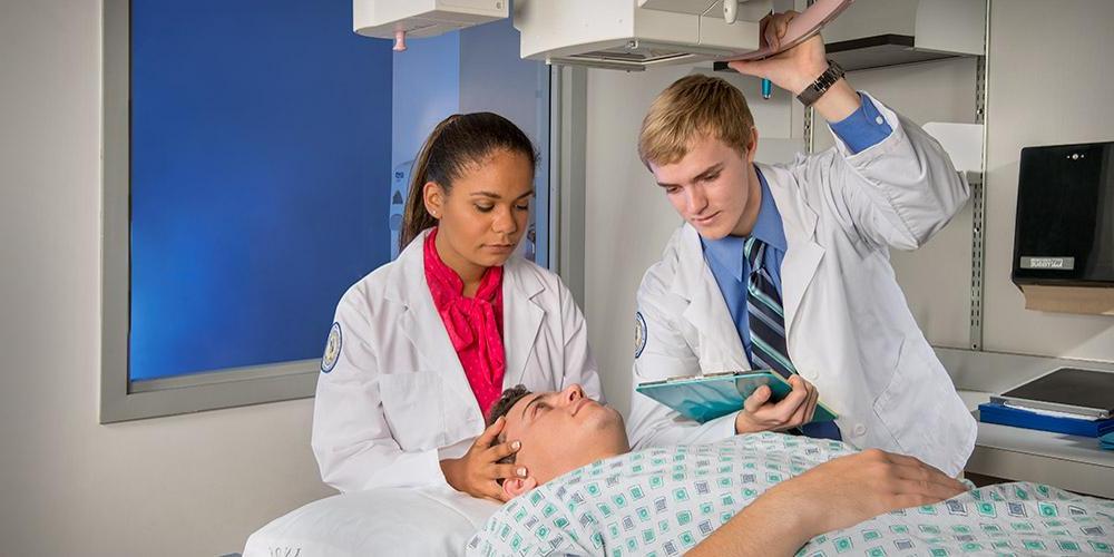 Two students doing scan of patient