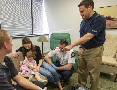 Physician instructor guides paramedic students in a simulation