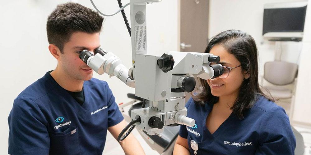 Residents utilizing ophthalmology equipment