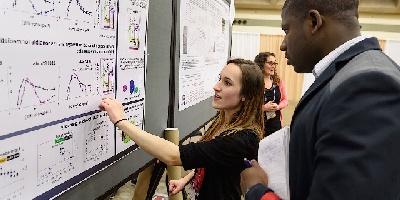 Rose Pasquale explains her research poster at the annual meeting of the Association for Research in Vision and Ophthalmology (ARVO) in Baltimore, Md.