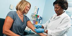 nurse drawing blood from patient